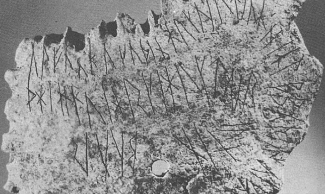 Human skull ribe fragment with runes